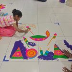daughter and mom doing ranggoli