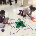 ladies doing ranggoli